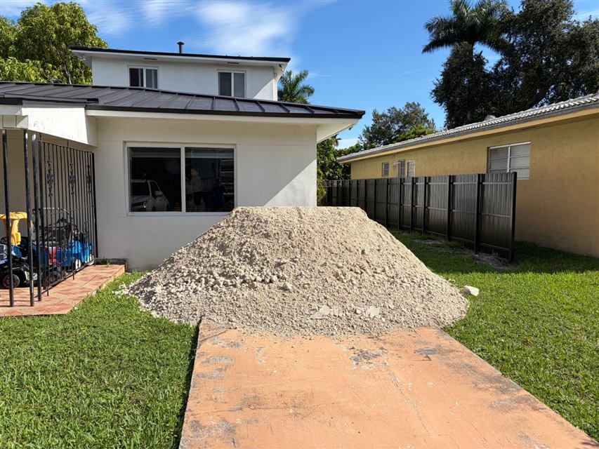 Load of limerock fill delivered to a home side yard in South Florida