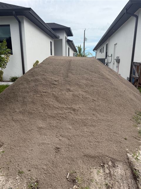 Load of fill dirt delivered between two new homes