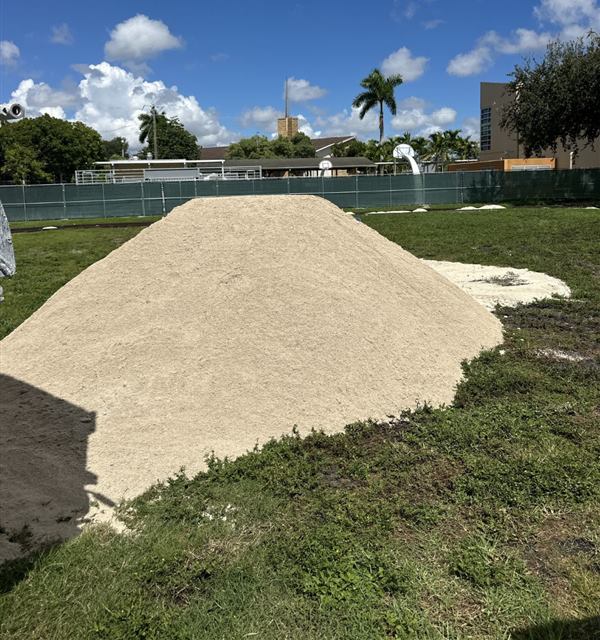 Sand delivered to a school field in Miami