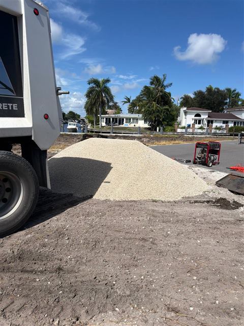 Limestone gravel dumped from the truck at a waterfront job site